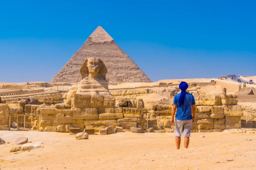 young-man-walking-towards-great-sphinx-giza